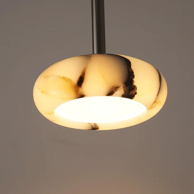 Gold pendant light with LED label on a gray background