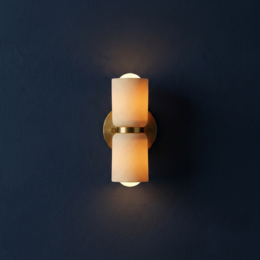 AX163 ceramic wall sconce glowing on a navy blue wall, Scandinavian wall sconce with brass details