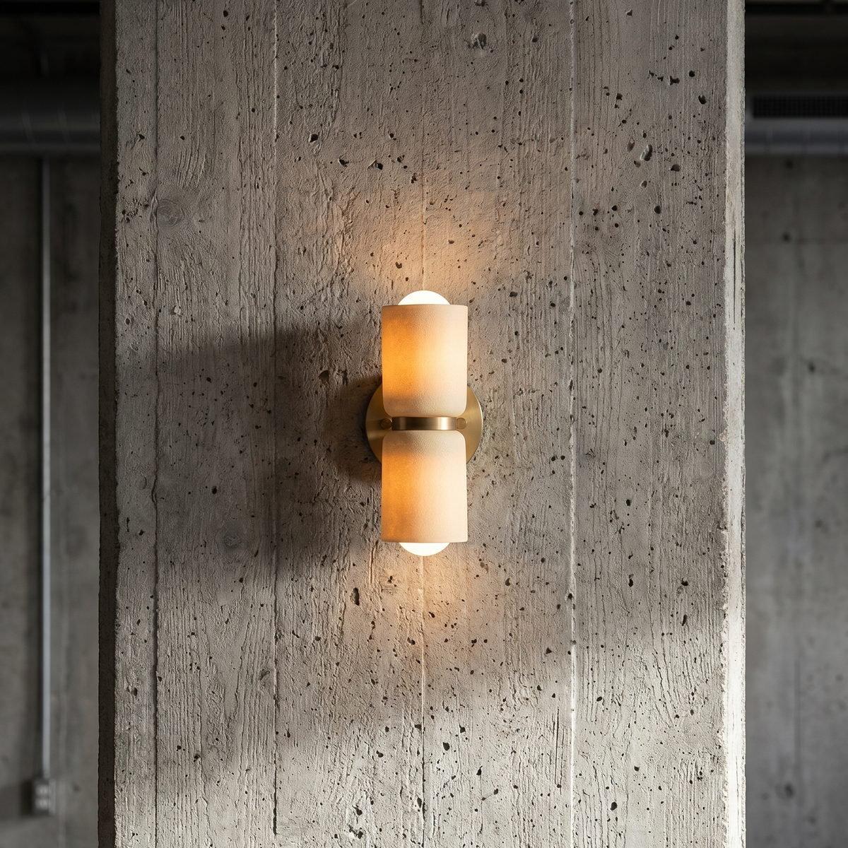 AX163 ceramic up down wall sconce on a raw concrete wall, minimalist brass wall light for a loft